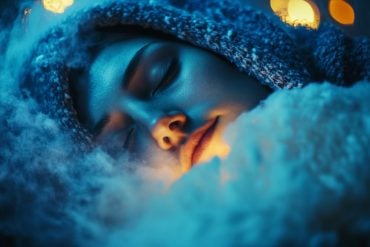 This shows a woman sleeping in a wooly blanket.