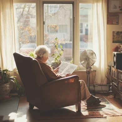 This shows an older woman doing a crossword.