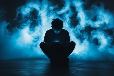 This shows a sad kid looking at a phone.