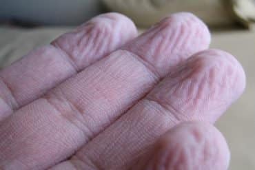 This shows wrinkled fingers.