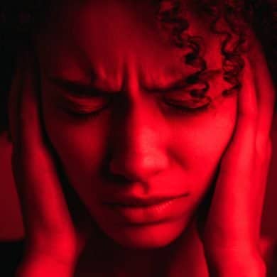 This shows a woman holding her head in pain.