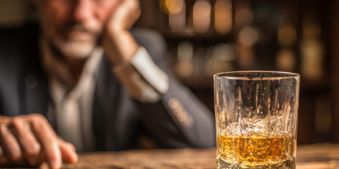 This shows a man and a glass of whiskey.