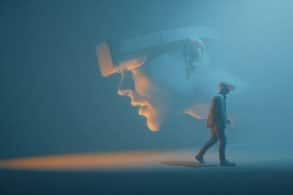 This shows a person walking away from an oversized face.