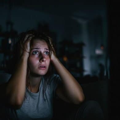 This shows a person holding their head while watching a movie.