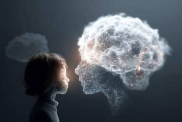 This shows a person looking at a cloud covered, digital head, symbolizing a human connection with AI chatbots.