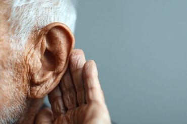 This shows an older man cupping his ear.