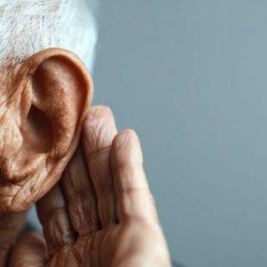 This shows an older man cupping his ear.