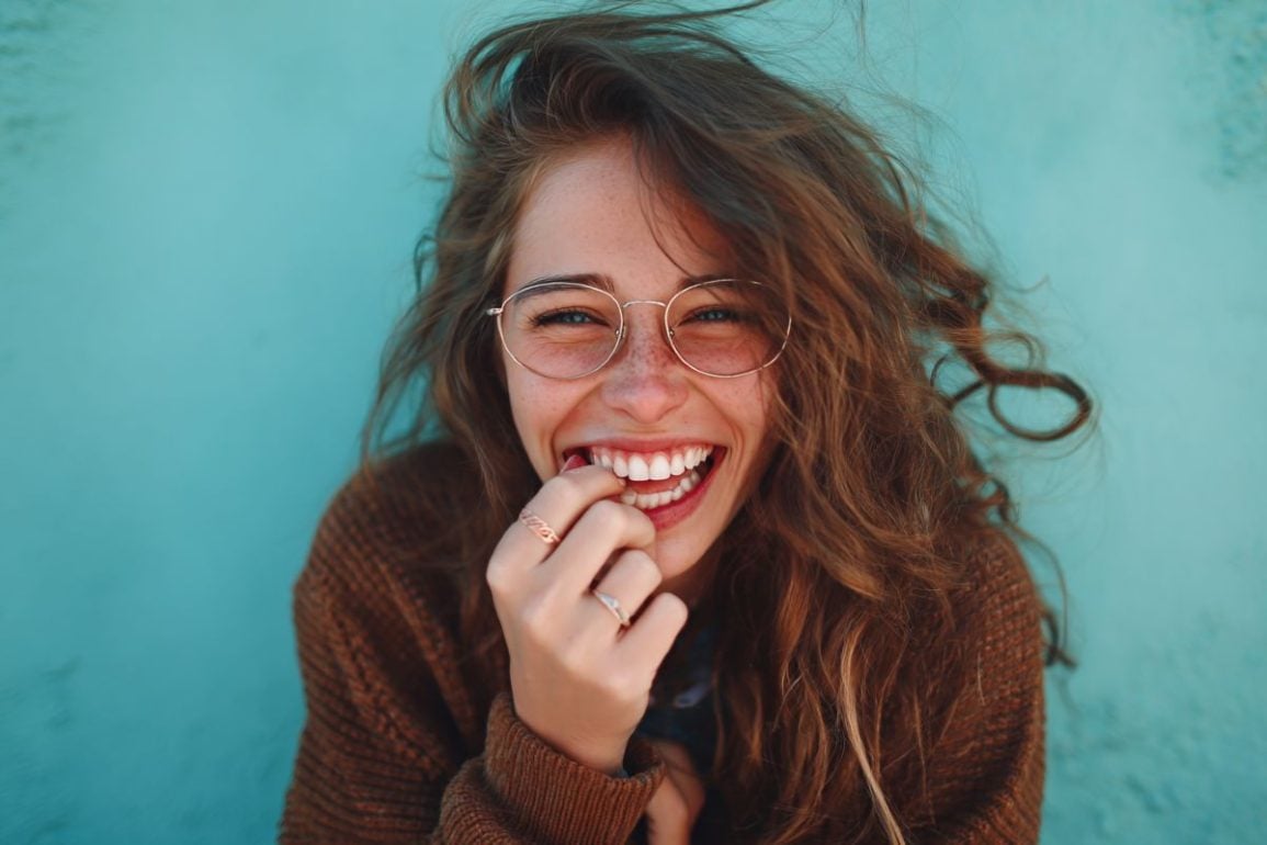 This shows a woman chewing her fingernails.
