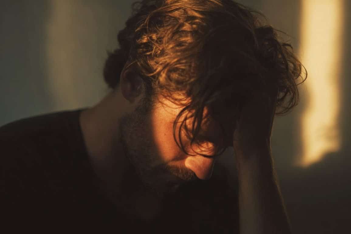 This shows a man holding his head.