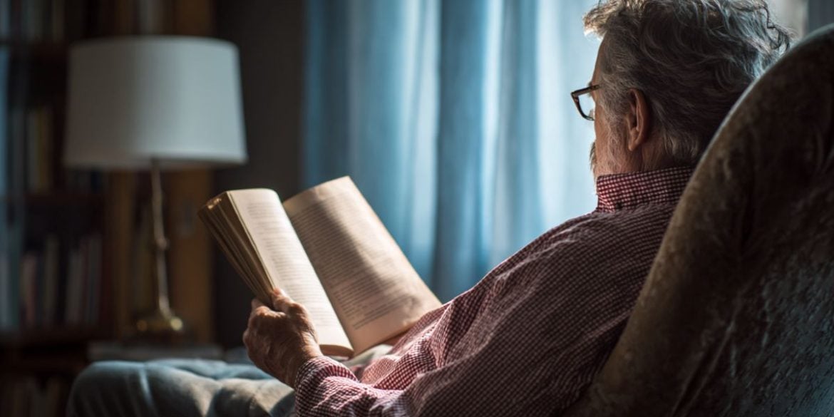 This shows an older person reading a book.