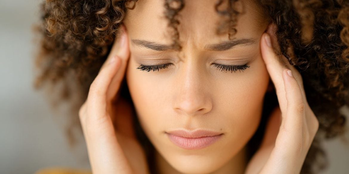 This shows a woman holding her head in pain.