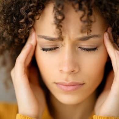 This shows a woman holding her head in pain.