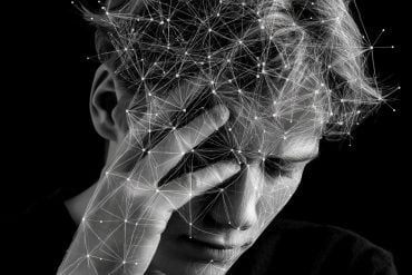 This shows a person holding their head overlayed with a network of lines.