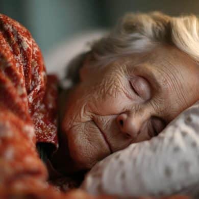This shows a sleeping older woman.