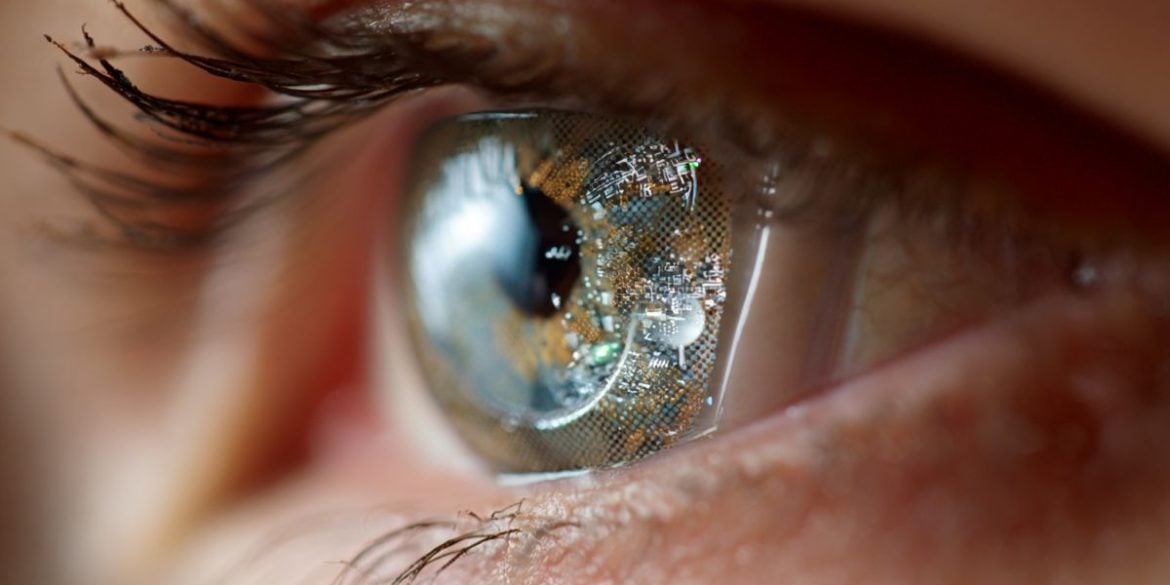 This shows a woman with a digital contact lense on her eye.