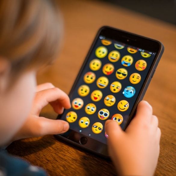 This shows a kid using an app full of emojis.