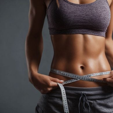 This shows a woman measuring her waist.