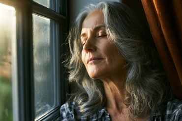 This shows a woman standing at a window.