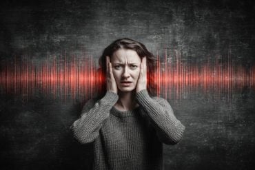 This shows a woman holding her ears, surrounded by sound waves.