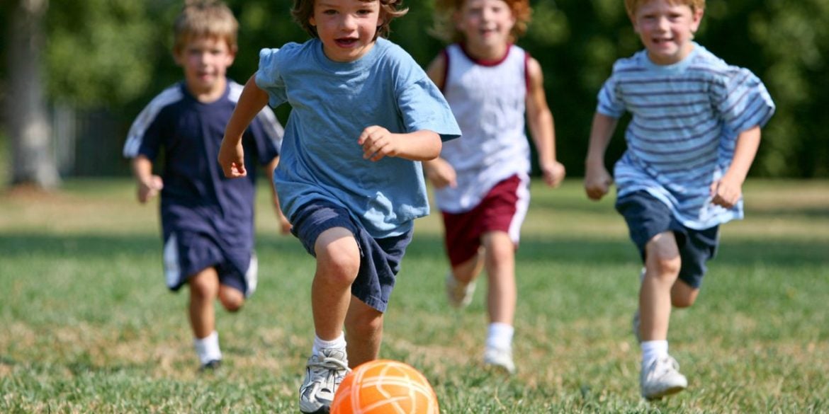 This shows young kids playing soccer.