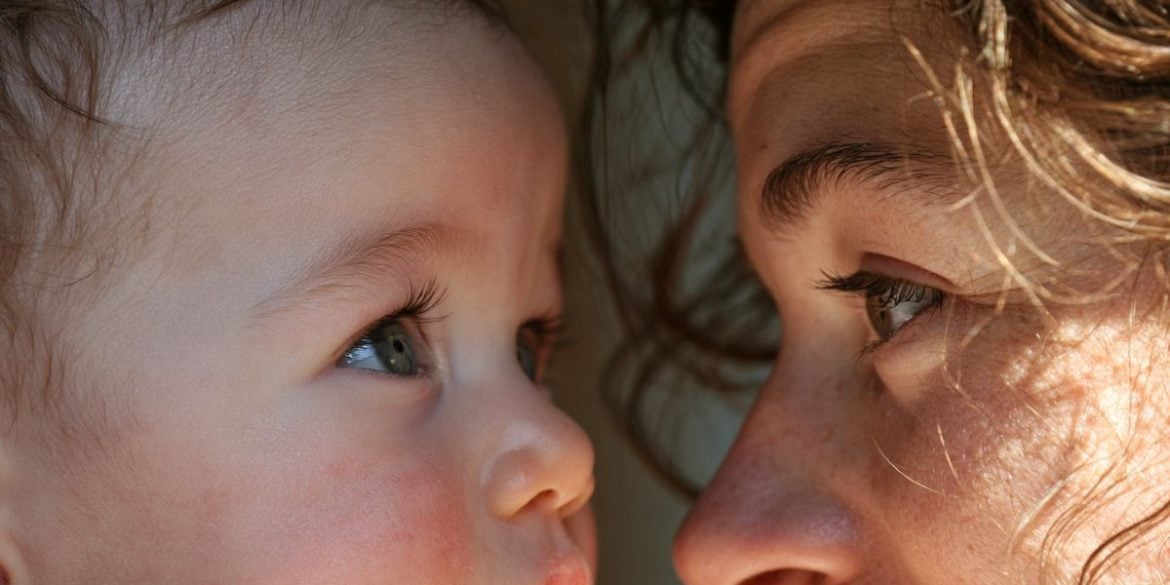This shows a baby looking at its mother.