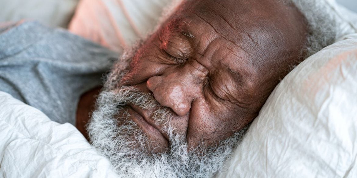 This shows an older man sleeping.