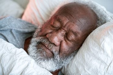 This shows an older man sleeping.