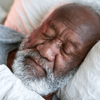 This shows an older man sleeping.