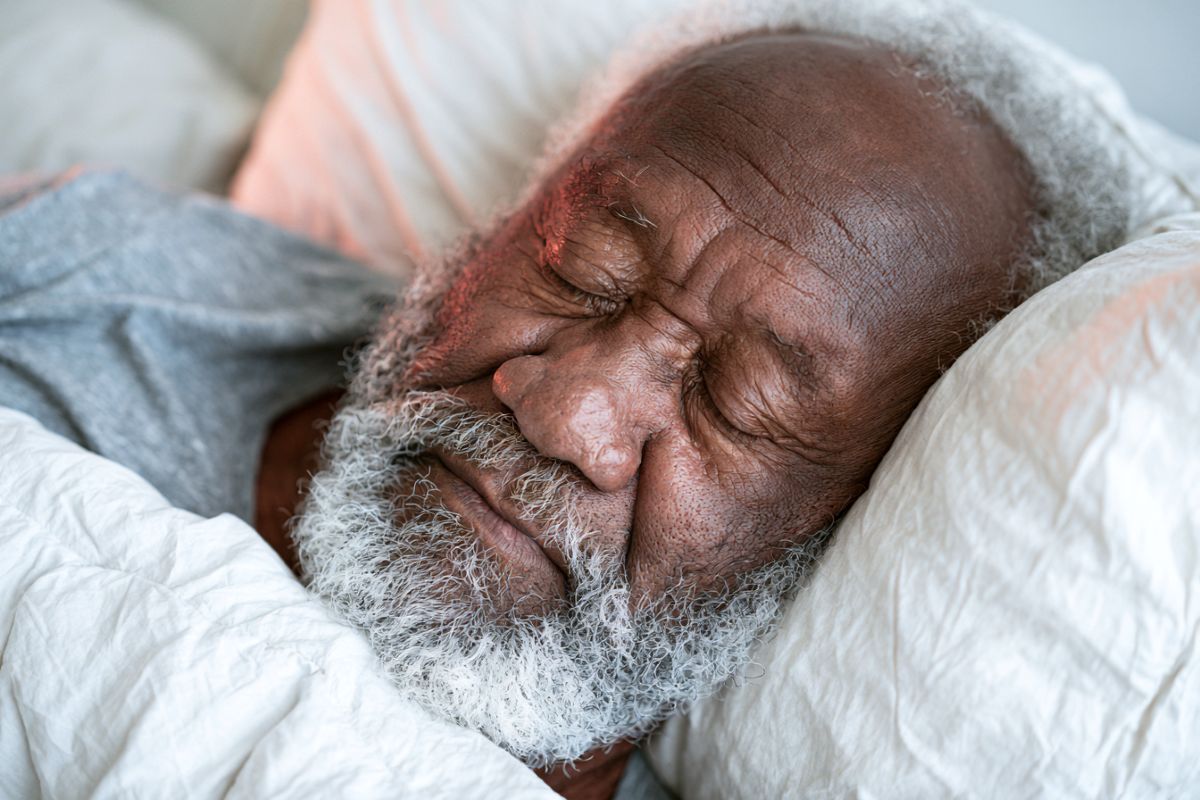 This shows an older man sleeping.