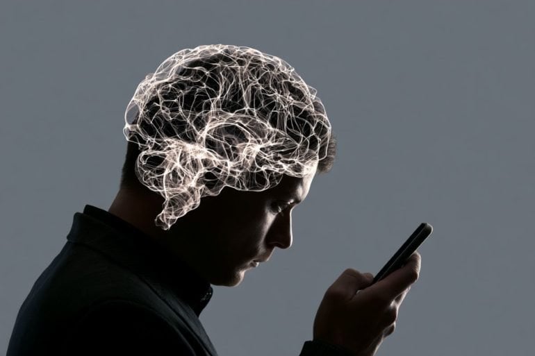this shows a person looking at a phone and a brain.