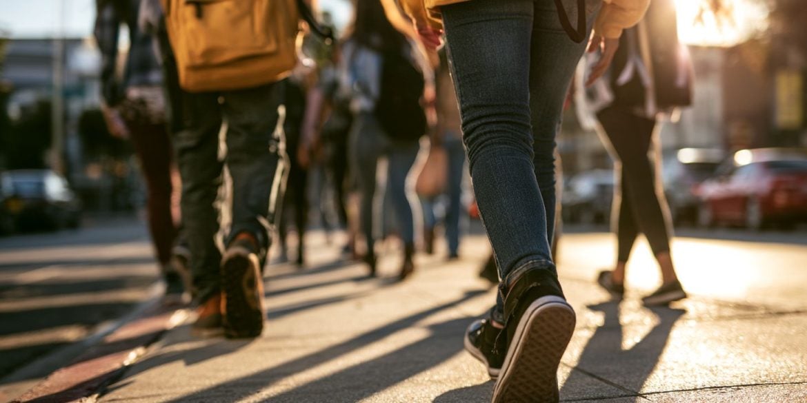 This shows teens walking to school.