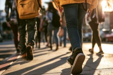 This shows teens walking to school.