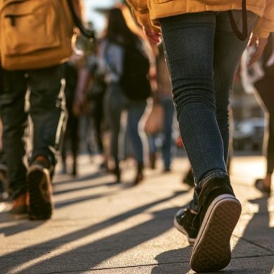 This shows teens walking to school.