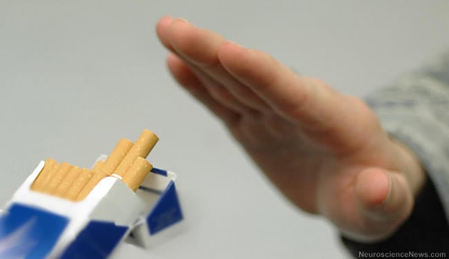 A hand is shown waving off a pack of cigarrettes.